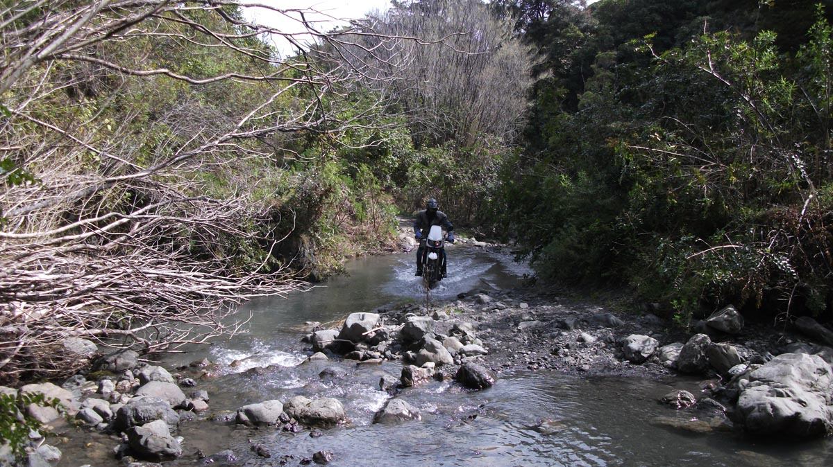 A rider crosses a stream on the way to Sutherlands Hut